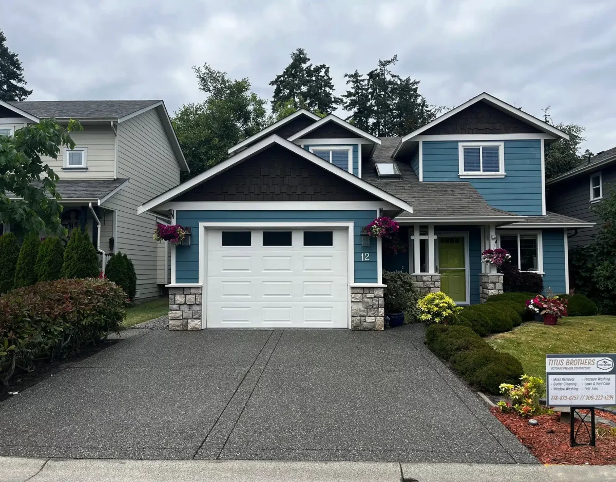 House after professional moss removal, gutter cleaning, window washing, driveway pressure washing, and sealing by Titus Brothers.